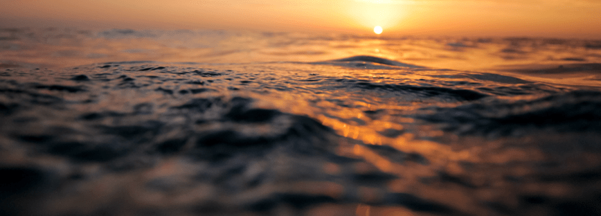 A sun rising, or is it setting, over the wide open ocean